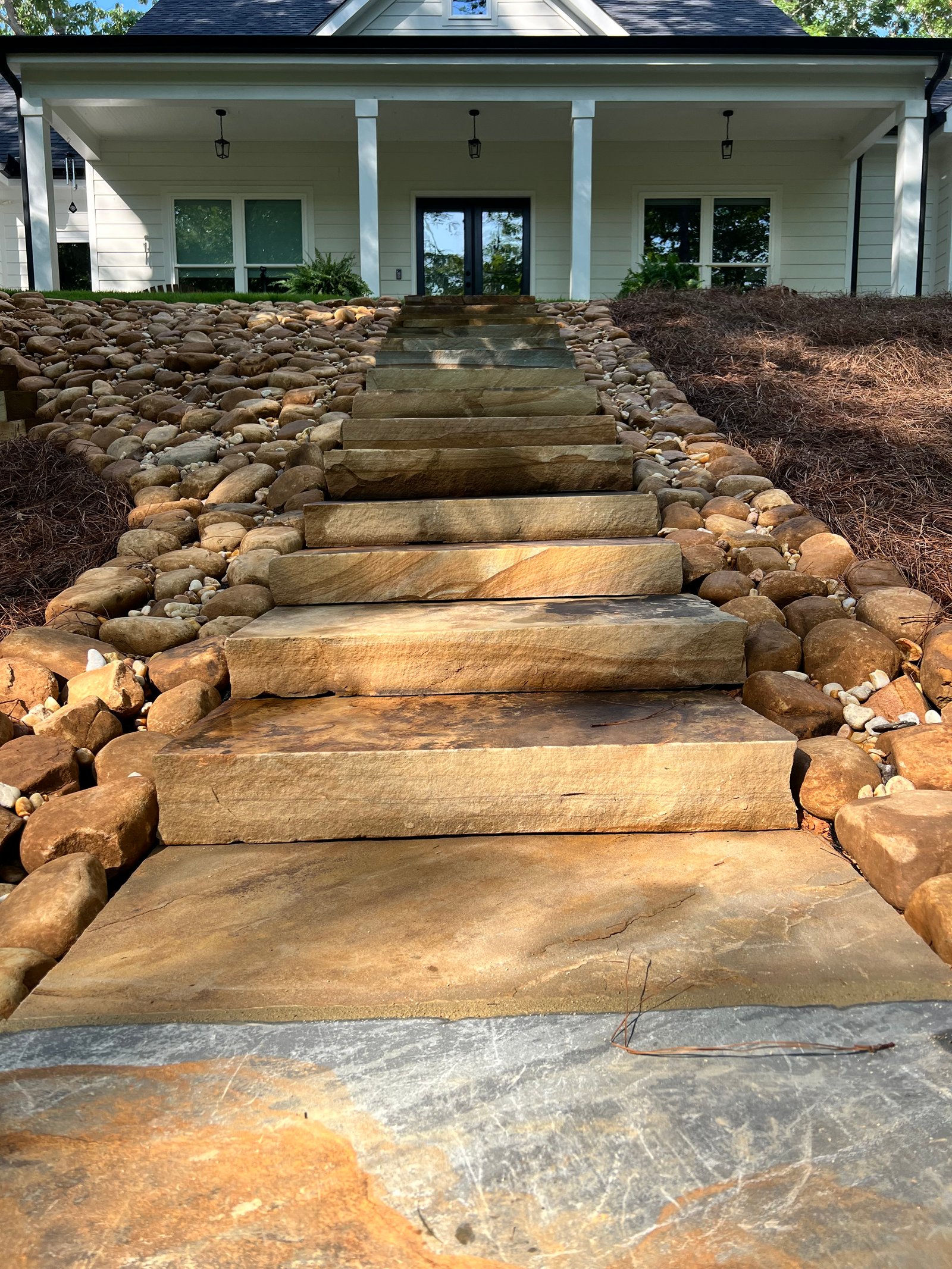 Completed stone staircase and river rock